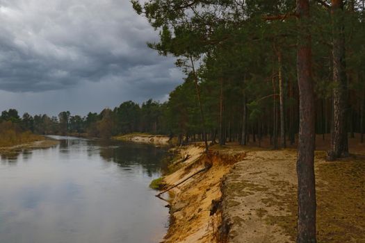 View of a winding river during a thunderstorm, out of focus