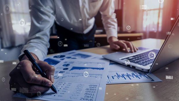 Businessman accountant or financial expert analyze business report graph and finance chart at corporate office. conceptual of finance economy, banking business and stock market research.