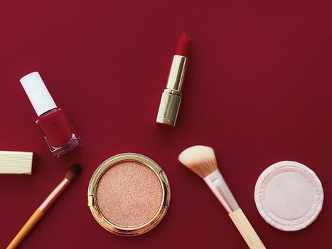 Beauty, make-up and cosmetics flatlay design with copyspace, cosmetic products and makeup tools on burgundy background, girly and feminine style concept