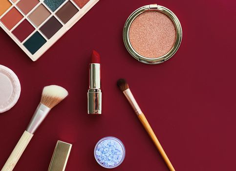 Beauty, make-up and cosmetics flatlay design with copyspace, cosmetic products and makeup tools on burgundy background, girly and feminine style concept