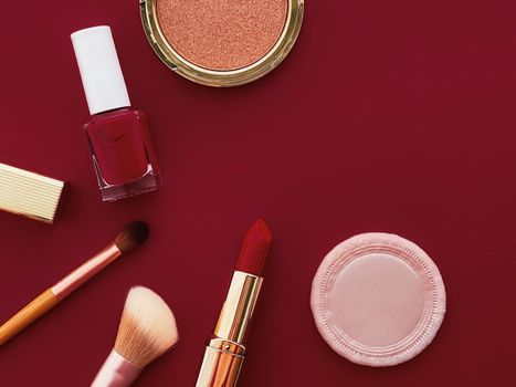 Beauty, make-up and cosmetics flatlay design with copyspace, cosmetic products and makeup tools on burgundy background, girly and feminine style concept