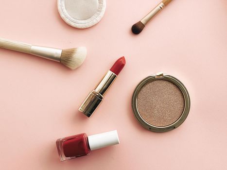 Beauty, make-up and cosmetics flatlay design with copyspace, cosmetic products and makeup tools on peach background, girly and feminine style concept