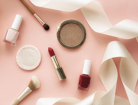 Beauty, make-up and cosmetics flatlay design with copyspace, cosmetic products and makeup tools on peach background, girly and feminine style concept