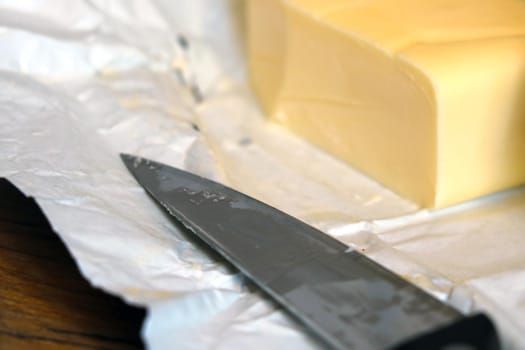 A piece of butter with a knife