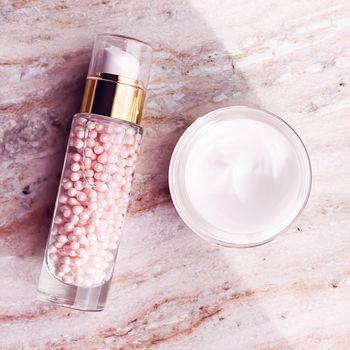 Skincare cosmetics, face cream moisturiser jar and golden serum emulsion in bottle, beauty product flatlay view