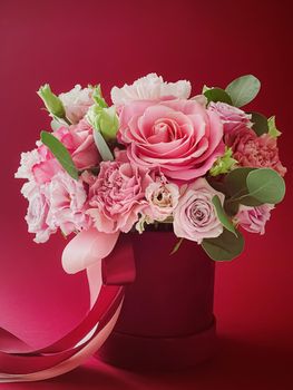 Beautiful flower box on red background, bouquet of blooming flowers as holiday gift, luxury floral design concept