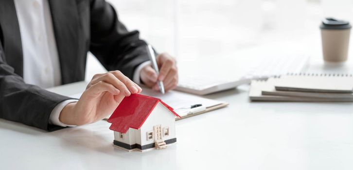 Real estate agent or bank officer describes the loan interest to the customer with home purchase contracts or on office loans and interest rates.