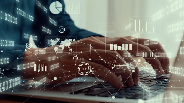 Businessman uses capable laptop computer to analyze business data analytic for marketing strategy and customer relationship management