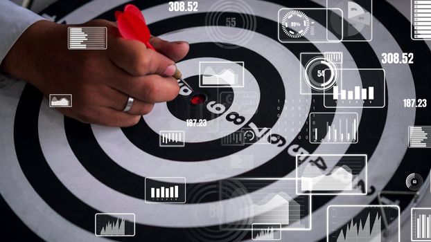 Businessman leader aiming at mission target. conceptual of challenge in business marketing bullseye and intelligent customer reach. The dart is strategy or skill. The dartboard is the project goal.