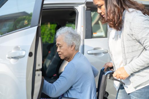 Asian senior or elderly old lady woman patient sitting on wheelchair prepare get to her car, healthy strong medical concept.