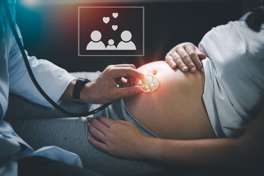 Doctor examining a pregnant woman.Young preganant woman expecting a baby doctor visit.