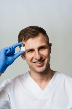 Coronavirus vaccine. Doctor holding covid-19 vaccine in his hands