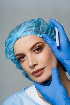 Blepharoplasty markup close-up on the face before the plastic surgery operation for modifying the eye region of the face in medical clinic.