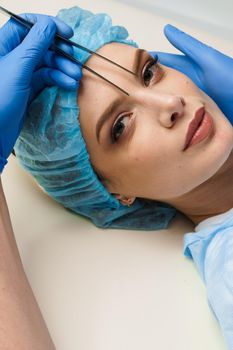 Blepharoplasty markup close-up on the face before the plastic surgery operation for modifying the eye region of the face in medical clinic.