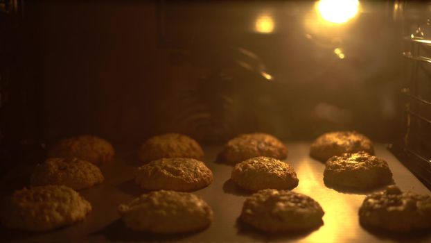 American cookies are baked in an oven. The cookies rise quickly in timelapse. 4k