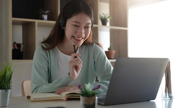 Curious Asian students while studying online on the internet and laptop video conferencing teachers at home..