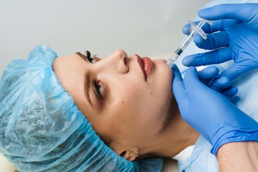 Filler injection of hyaluronic acid. Contour plastic for correcting the volume and shape of the nose, chin, cheekbones, temples.