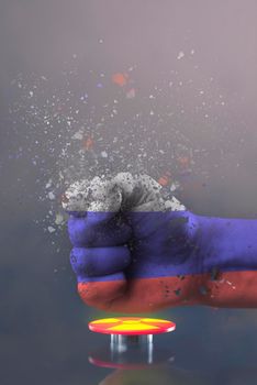 The threat of nuclear war. Russia threatens the world with nuclear weapons. A fist painted in the colors of the Russian flag presses a large red button with the symbol of a nuclear weapon