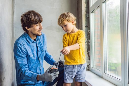 Father and son repair windows together. Repair the house yourself.