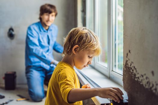 Father and son repair windows together. Repair the house yourself.