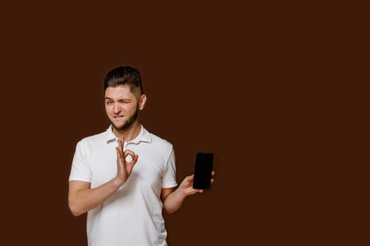 Manager with phone calls and shows ok. Empty left side for advert. How to make online order in restaurant for delivery. Isolated brown backround