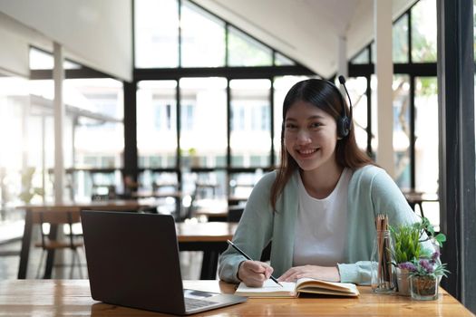 Asian women chatting in video conferencing or virtual meeting at home. Look at the camera.