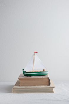 Boat model with old books on the table