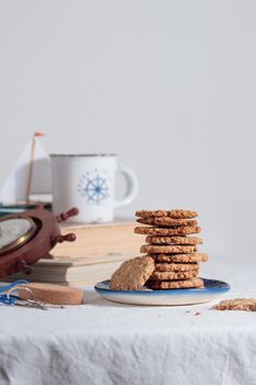 Cup of coffee with cookies in a sailing style on a table