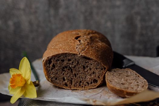 Mad is holding basket with freshly homemade wholemeal bread. Easy Cooking of healthy bread from alternative flours.