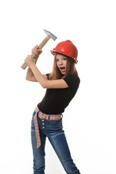 A girl in a hard hat hits herself on the head with a hammer, surprise on her face