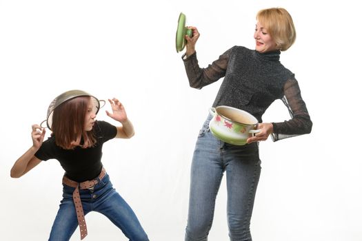 Mom and daughter have fun using kitchen utensils