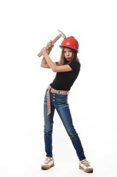 A girl in a hard hat hit her hard hat with a hammer, a malicious expression on her face