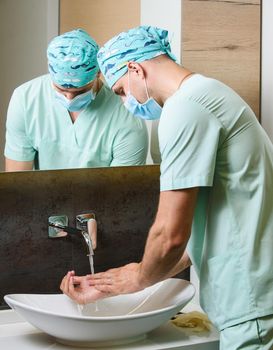 Hygiene of man. Medical staff wash hands. Disinfection for hands under water and soap to stop coronavirus covid 19.