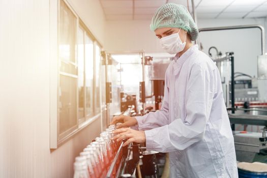 Beautiful worker working in hygiene and clean drink factory in european country.