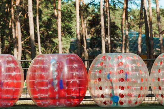 Bubble ball balloons on the green field. equipment for team building sport game named bumper ball or bubble ball.