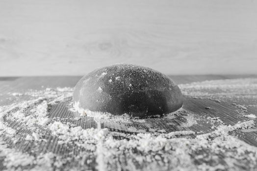 Black dough ball with flour. Cooking black pizza with italianblack dough. Food blanks in restaurant.