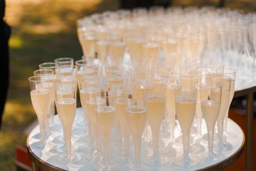 Aperitif champagne for business meeting conference participants. Welcome drink zone with champagne in disposable plastic wine cups.