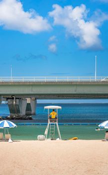 okinawa, japan - september 15 2021 Beach umbrellas and Lifeguard chairs on the sandy beach Naminoue in Naha City in Okinawa Prefecture, Japan.