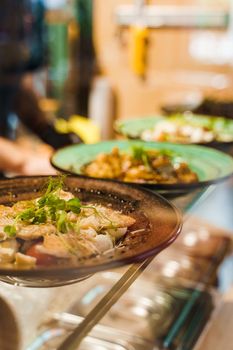 Salads in fast food restaurant according to social distance. Take away food in cafe in qarantine period. Healthy salads on the plates.