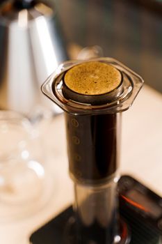 Aeropress in loft cafe. Aeropress is a device for brewing coffee. Alternative scandinavian method of coffee brewing in caffee, Barista makes coffee