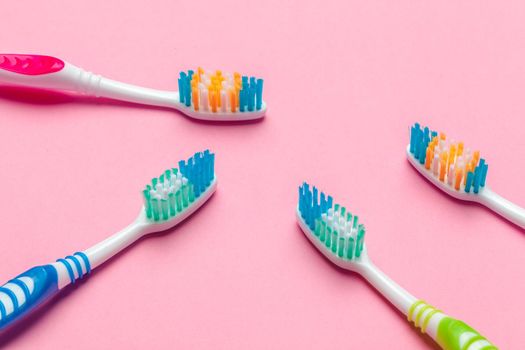 Toothbrushes on pink background. Close up.