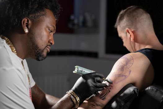 Cinematic shot of a Tattoo artist creating Body art at the tattoo studio. High quality photography