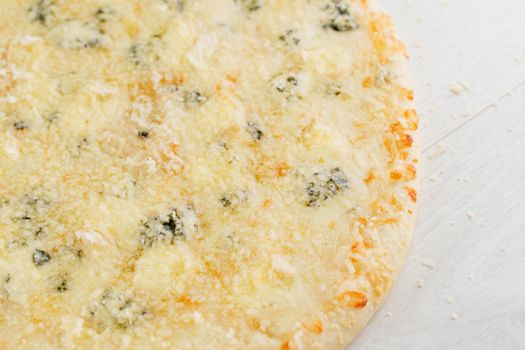 Pizza with cheese such as parmesan, hard cheese, dor blue and mozzarella isolated on white wooden background. Advert for social network of restaurants, caffee