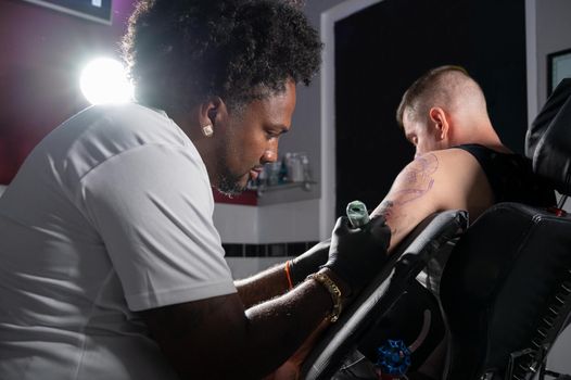 Cinematic shot of a Tattoo artist creating Body art at the tattoo studio. High quality photography