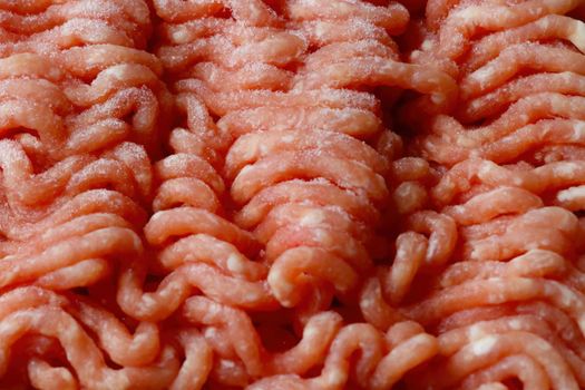 Close-up on red frozen minced meat. Background