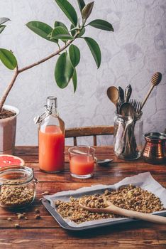 Healthy breakfast with homemade granola and freshly squeezed grapefruit juice