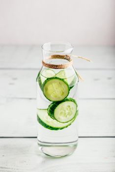 Infusion with sliced cucumber in glass bottle