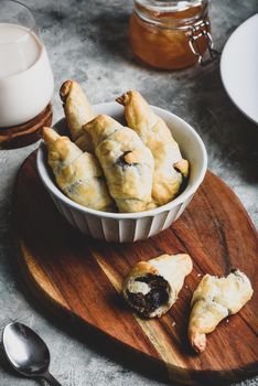 Bowl of fresh baked croissants stuffed with nuts and chocolate spread