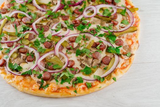 pizza with sausages, cucumber, pepper, cheese, onion isolated on white wooden background. Advert for social network of restaurants, caffee. Promotion for pizzeria