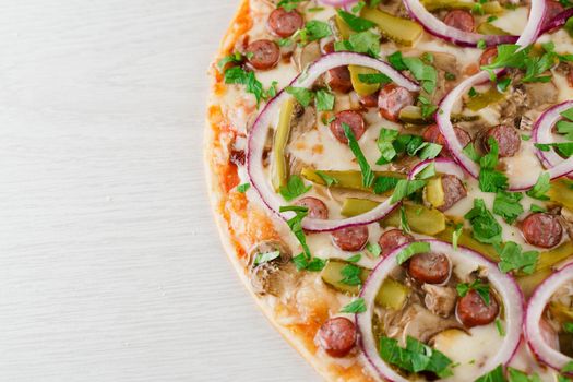 pizza with sausages, cucumber, pepper, cheese, onion isolated on white wooden background. Advert for social network of restaurants, caffee. Promotion for pizzeria